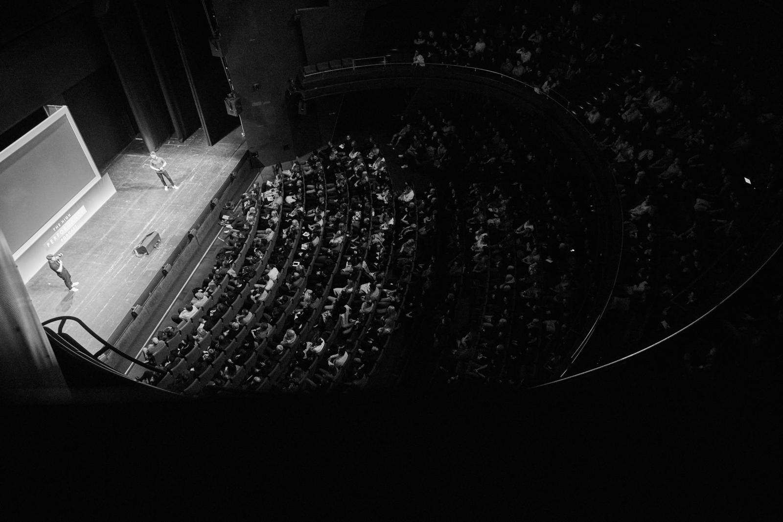 A Tempest Two speaker addressing a full theatre