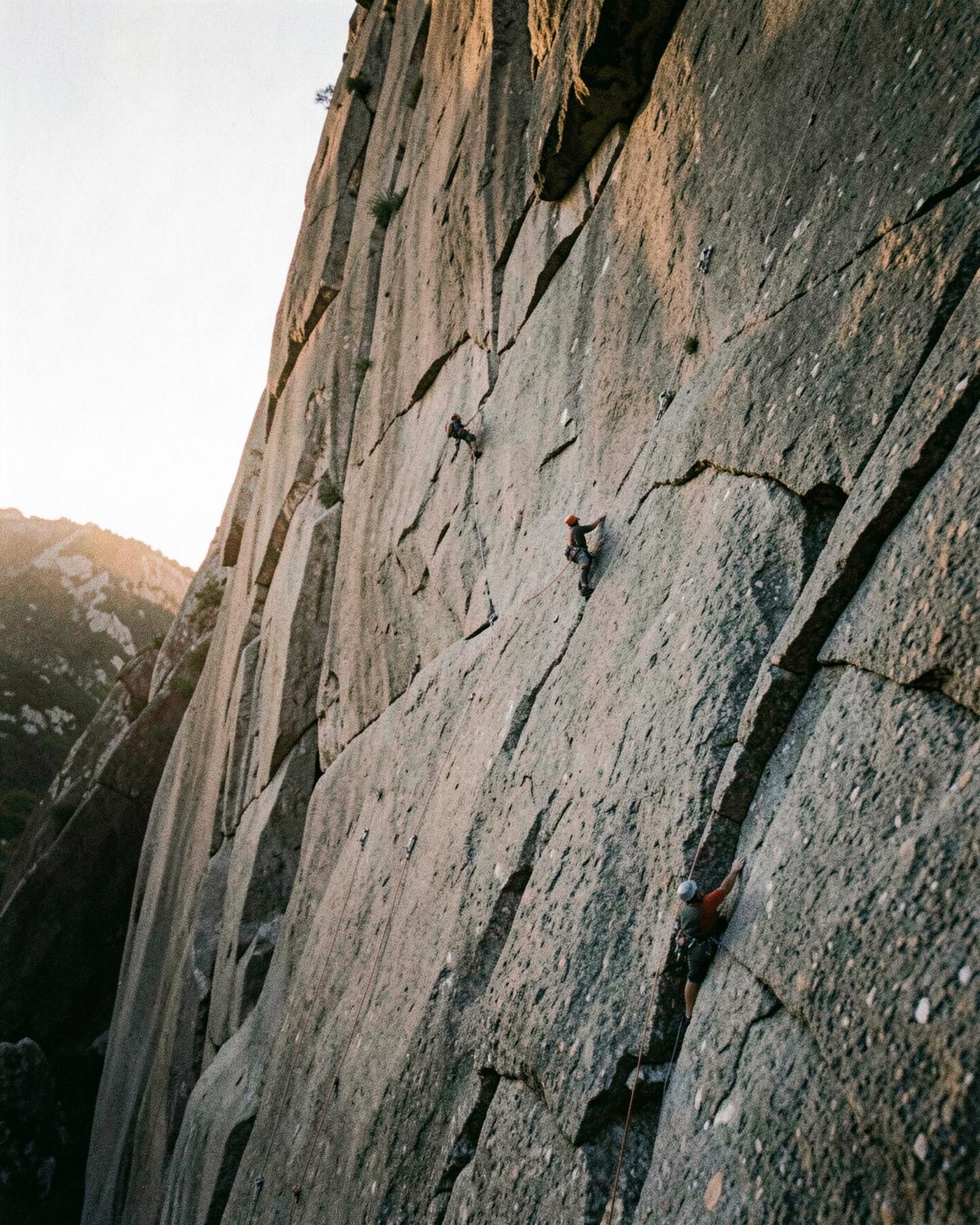 Climbers on a vast granite wall